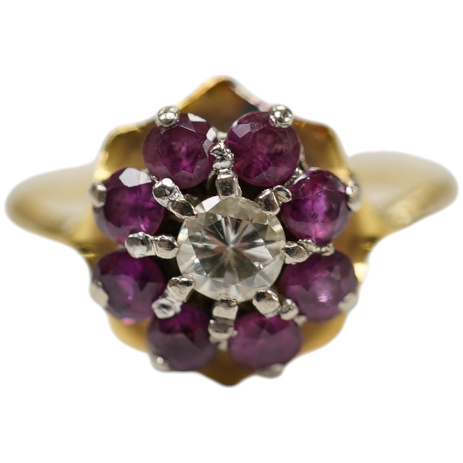 An 18ct, ruby and diamond set circular cluster ring, size O, gross weight 3 grams. Condition - fair